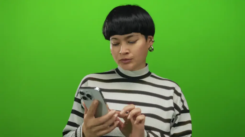 Junge Frau mit Smartphone und Ohrringen