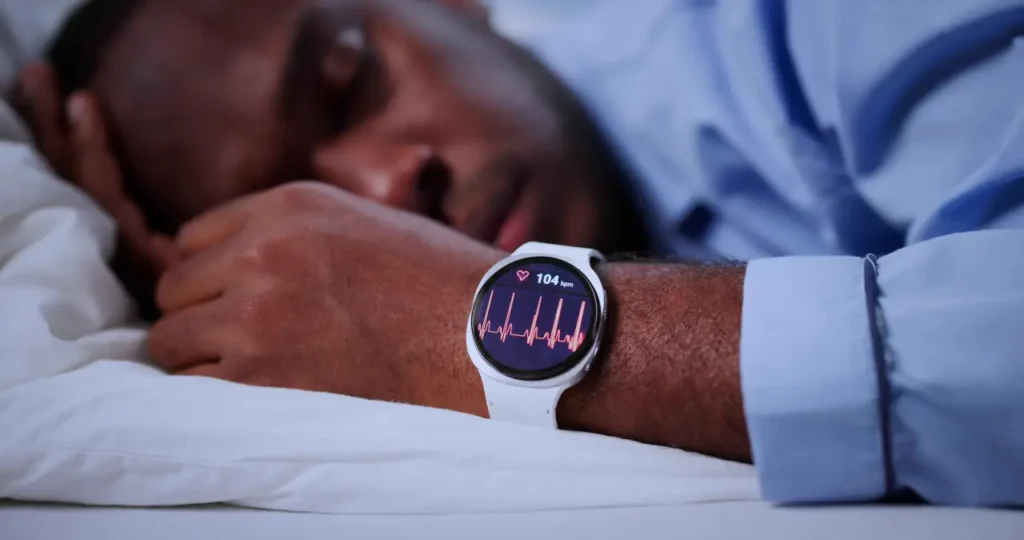 Mann schläft mit Smartwatch