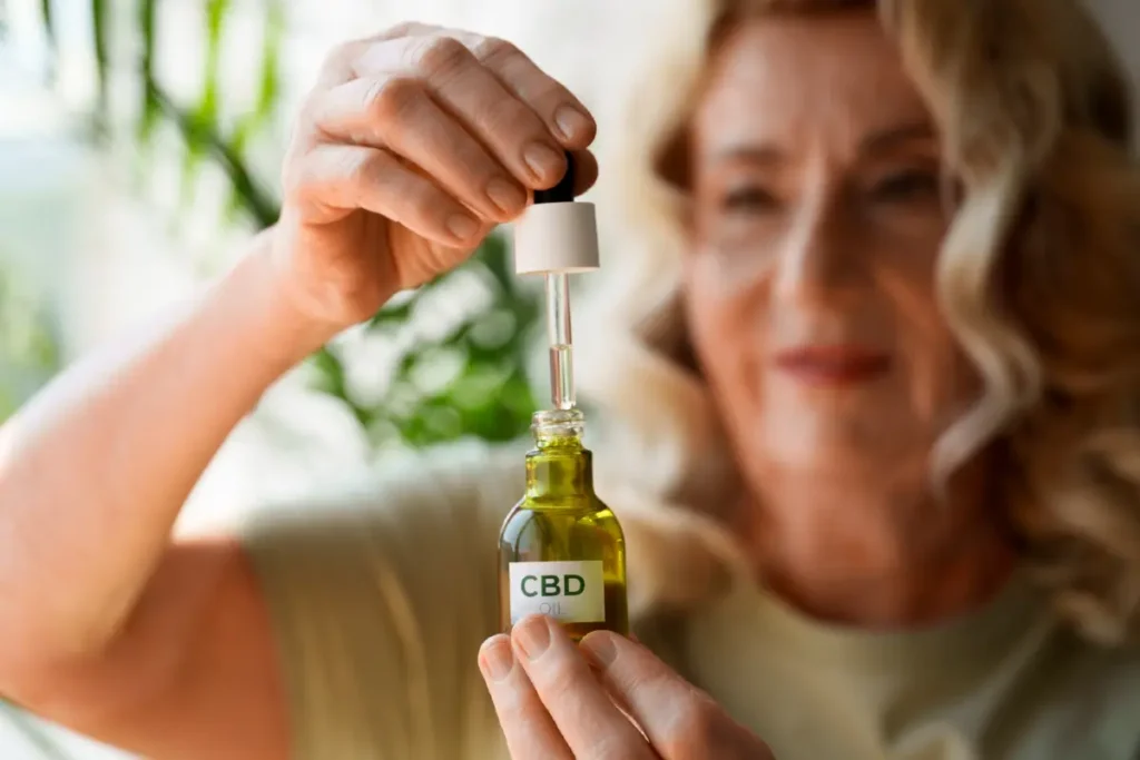 Frau hält eine Flasche CBD-Öl mit Pipette in den Händen