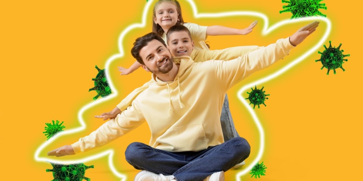 Père heureux avec ses enfants, symbolisant un système immunitaire fort en hiver